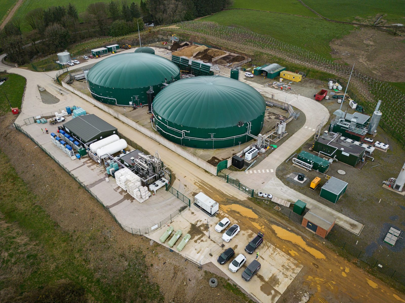 Aerial view of Crofthead Biogas, Dumfries, with two green digester tanks